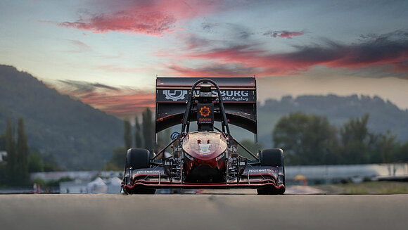 Unmanned vehicles with trucks and vans in the background