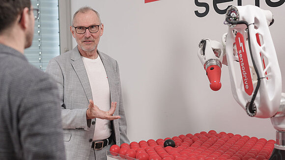 Unmanned vehicles with trucks and vans in the background