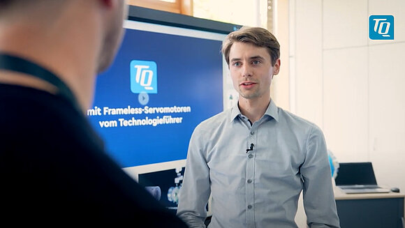 Unmanned vehicles with trucks and vans in the background